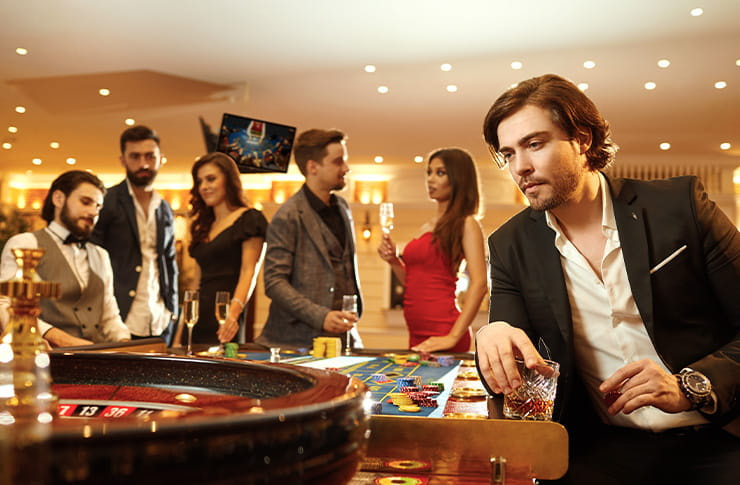 A Man With Glass of Whiskey Sitting on Casino Table