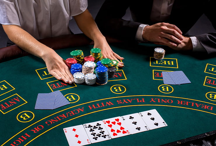 Person Holding Casino Chips on a Table