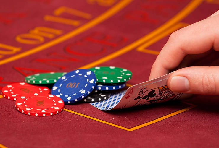 A Blackjack Table With Chips and King-Ace Hand